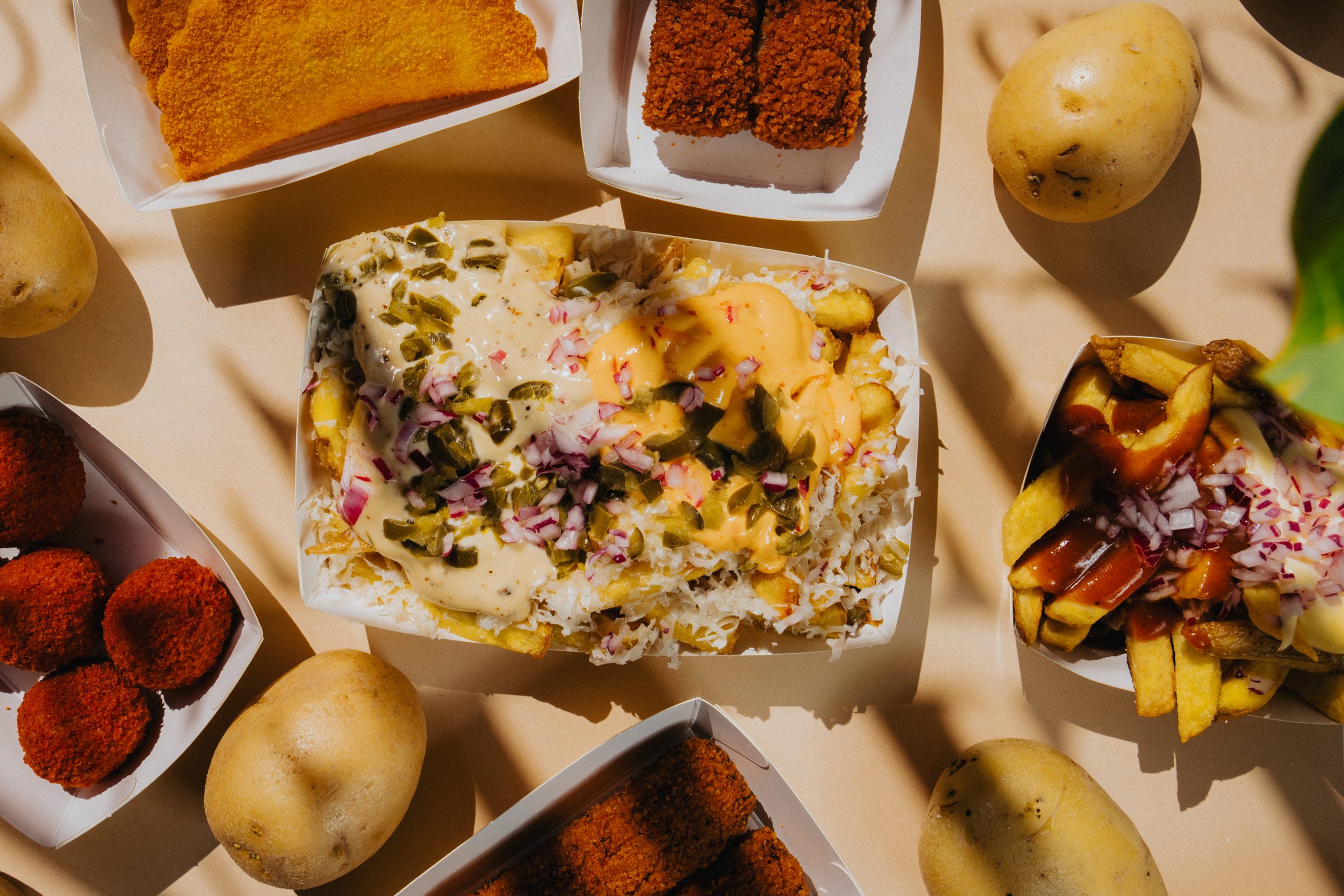 Golden Frites spread: loaded frites, bitterballen and kaassoufflé in branded trays